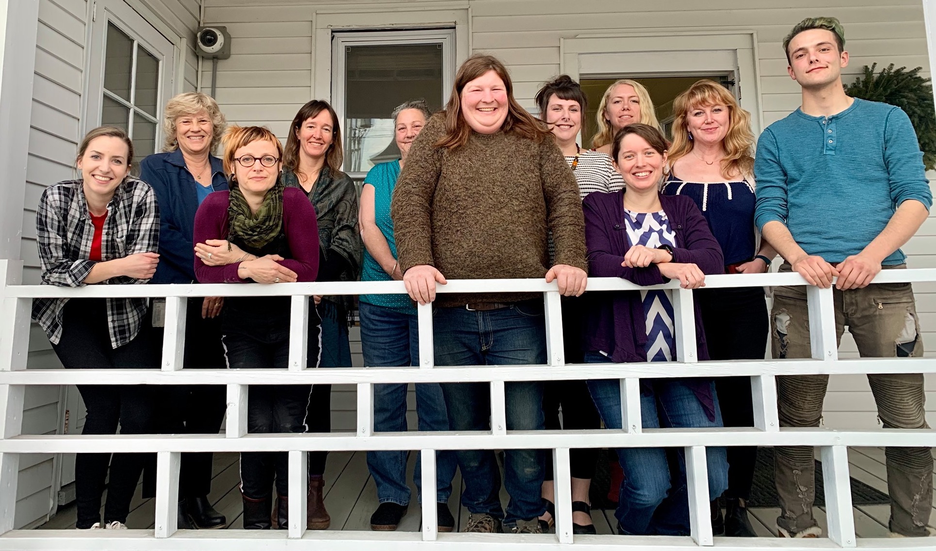 mosaic vermont team outside on the building's porch